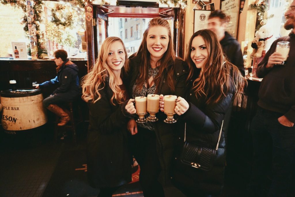 three girls drinking Irish coffee at the temple bar in Dublin ireland, cheers