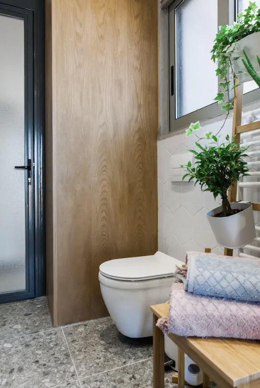 bathroom with greenery and fresh towels inside The Cutest Airbnb Vacation Rental In Athens, Greece