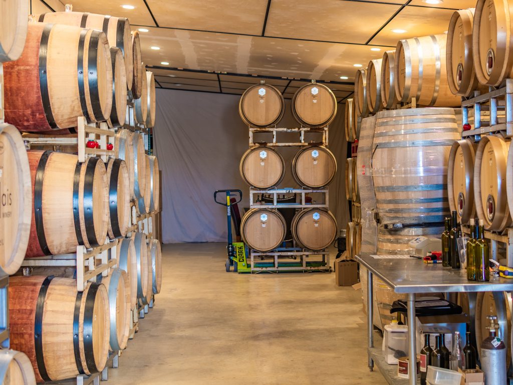 calais winery fredericksburg texas wine barrels in tasting room shed, calais winery tasting room, french winery fredericksburg texas, bordeaux style wines fredericksburg texas, french owned winery fredericksburg