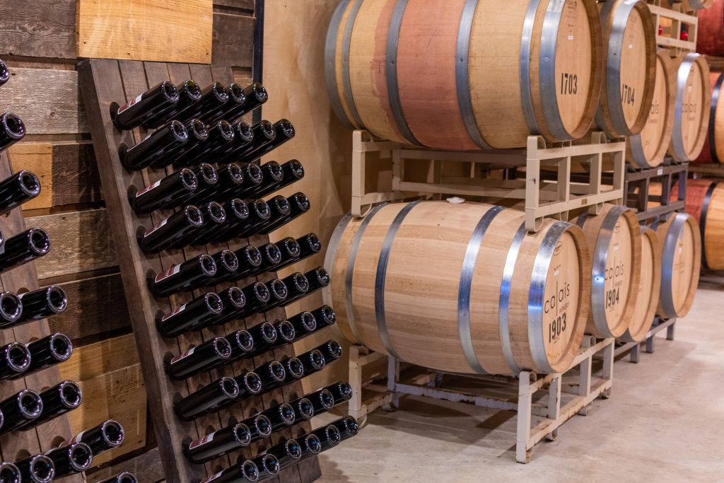 calais winery fredericksburg texas wine barrels in tasting room shed, calais winery tasting room, french winery fredericksburg texas, bordeaux style wines fredericksburg texas, french owned winery fredericksburg