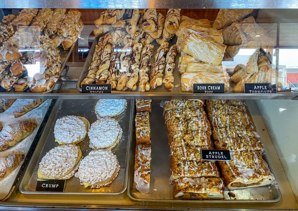 old german bakery and restaurant in fredericksburg texas, bakery display of fresh baked items at old german bakery, apple strudel, crump, cinnamon sticks, apple turnovers