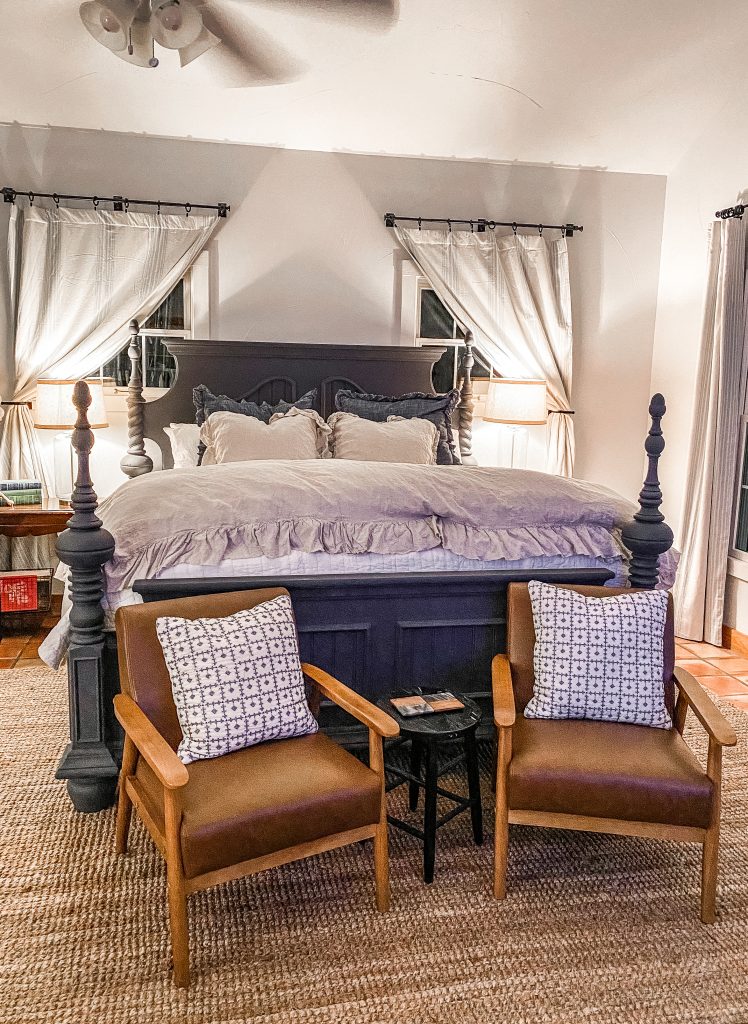 master bedroom with king size bed and decor in emma haus fredericksburg luxury vacation rental, airbnb rental in fredericksburg tx, charming rental in texas hill country