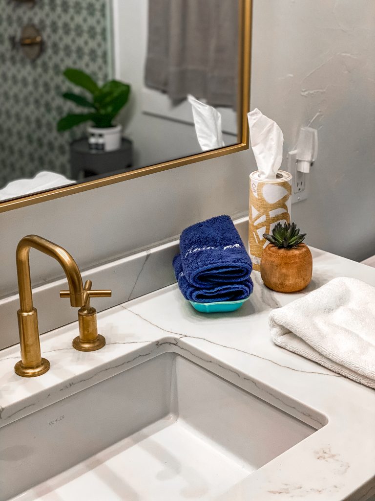 luxury bathroom in emma haus fredericksburg airbnb rental with marble/quartz countertops, gold faucets and luxury amenities, newly renovated bathroom in cute texas hill country cottage