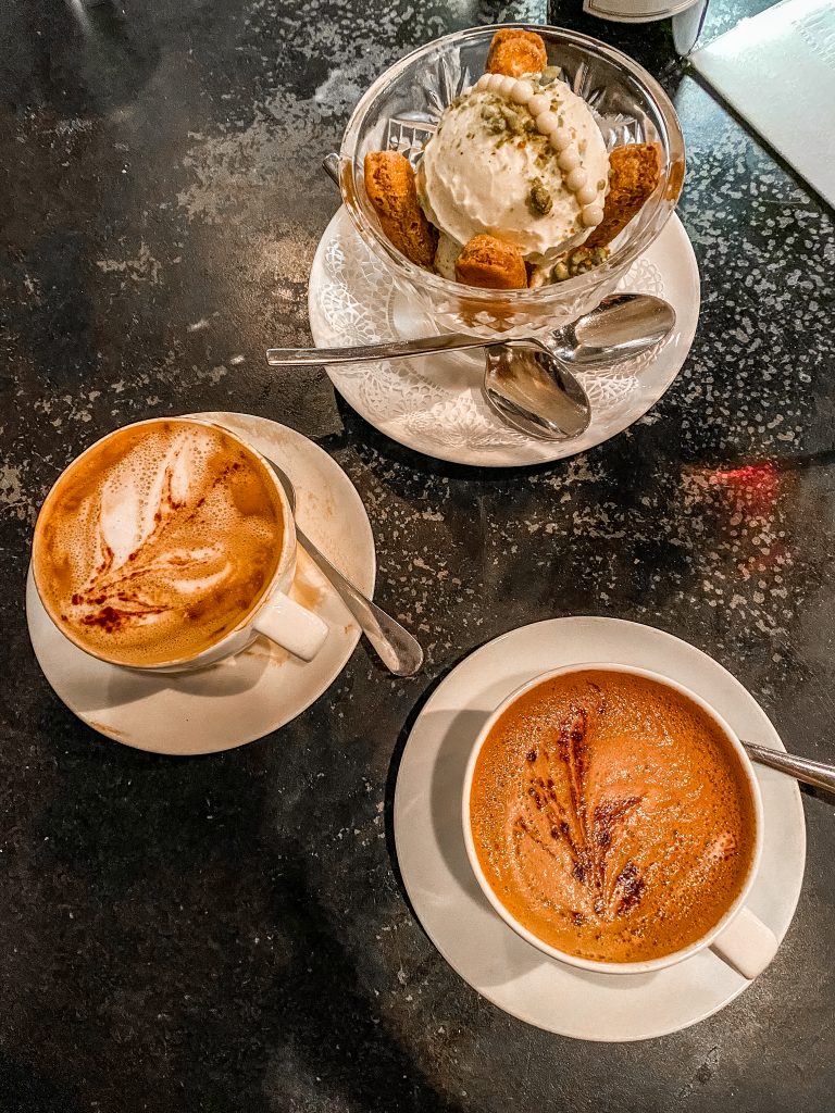 Pistachio Tiramisu dessert with 2 crafted cappuccinos at vaudeville bistro in fredericksburg Texas