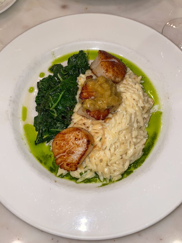 Pan seared scallops with creamy orzo, sautéed local greens with orange & fennel marmalade at 
Otto's German Bistro in fredericksburg texas, gourmet german cuisine in fredericksburg, tx