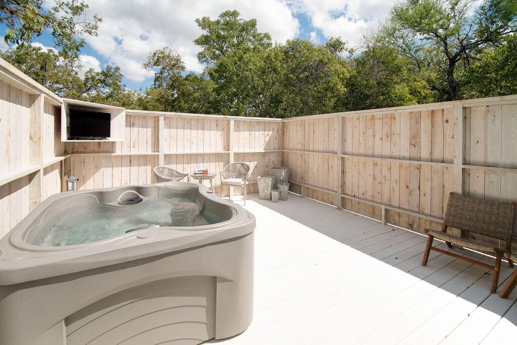 private hot tub and outdoor at porch light hospitality austin four twelve rental unit, modern farmhouse rental in fredericksburg, texas, where to stay in fredericksburg, tx, unit No. 3 at austin four twelve rental units, modern chic property rental