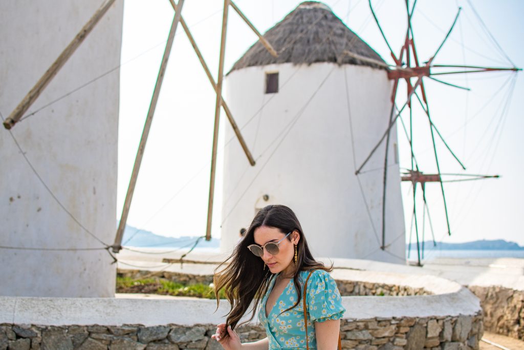 best things to do in mykonos, greece, visit the iconic windmills, girl exploring windmills in mykonos greece