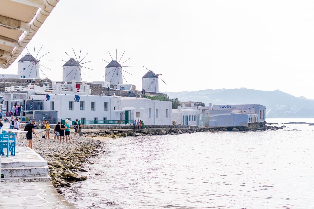 little venice in mykonos, greece, view of the famous windmills from Little Venice, restaurants along the water in Little Venice