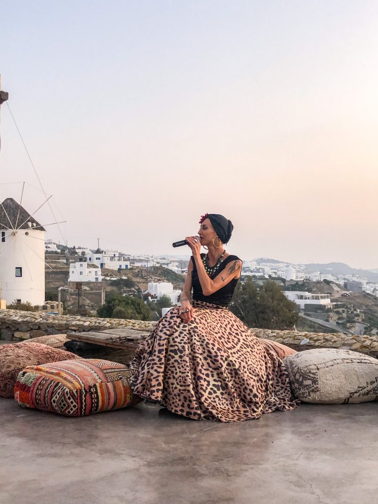 live music entertainment with sunset view at 180° Sunset Bar in Mykonos Greece overlooking Mykonos Town and the windmills. Where to watch the sunset in mykonos, the best things to do in mykonos greece